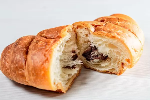 Croissant with chocolate filling on white background (Flip 2019)