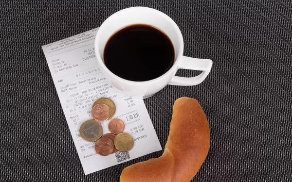 Croissant with coffee and reciept on white background