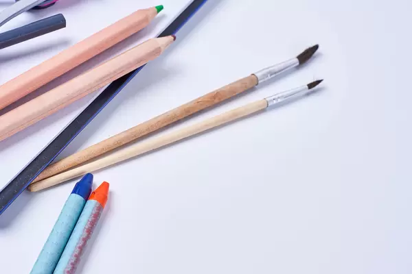 Cropped shot of colored crayons and brushes