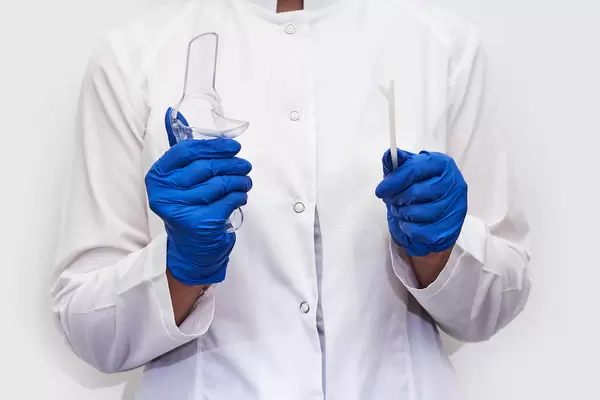 Cropped shot of gynecologist holding gynecology instruments