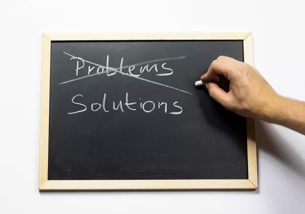 Crossing out problems and writing solutions on a blackboard