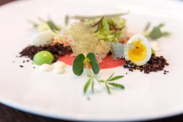 Crudo Nicoise at Chino Latino:  Yellow Fin, Wasabi–Pea Sphere, Black Olive Powder, Quail Egg, Lemon Oil