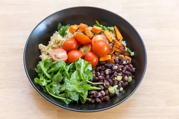 Cuban quinoa bowl: sweet potatoes, cherry tomatoes, rocket and red beans