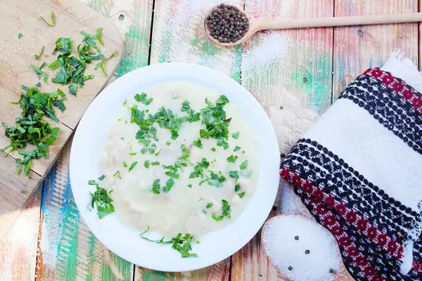 Cullama with chicken and mushrooms. Turkish cuisine on wooden vintage background (Flip 2019)