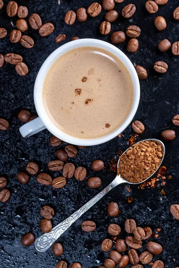 Cup of coffee, ground coffee and beans on dark background. Top view (Flip 2019)