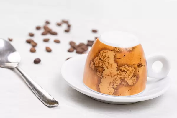Cup of Coffee with coffee beans on the table