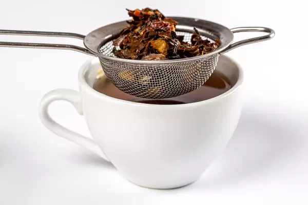 Cup of tea with metal sieve