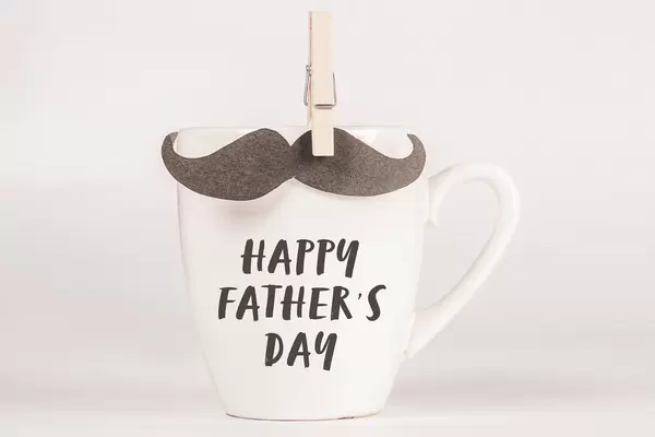 Cup with inscription Happy Father's Day and mustache with wooden clothespin