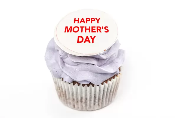 Cupcake with purple cream and happy mother's day inscription