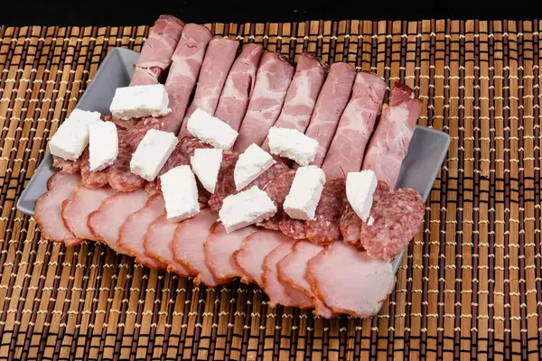 Cured Meat products served and arranged on the plate (Flip 2019)