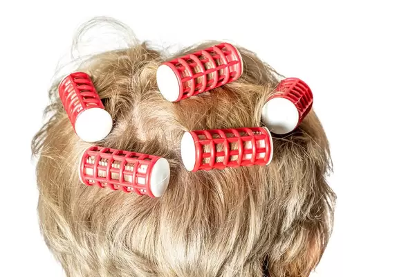 Curling woman hair with thermo curlers