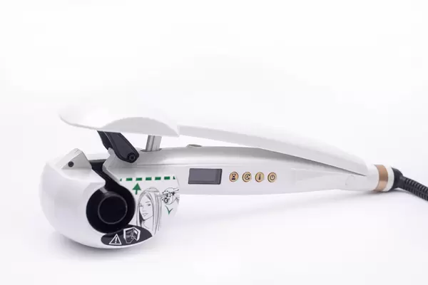 Curly hair machine for hairdressers isolated above white background