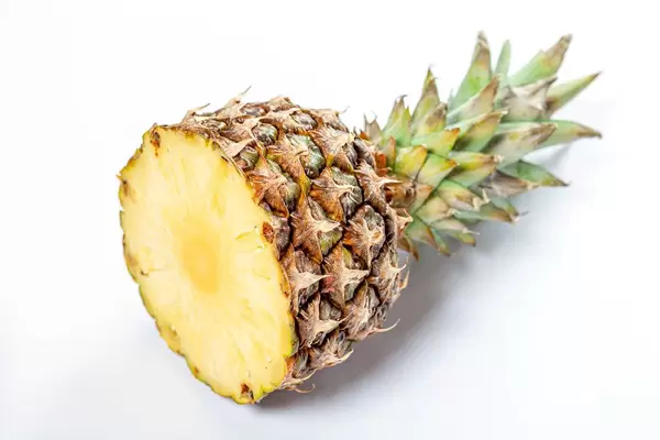Cut ripe pineapple on white background (Flip 2019)