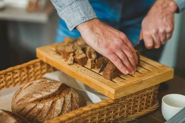 Cutting  Dark Bread Slices  On Wooden Board (Flip 2019)