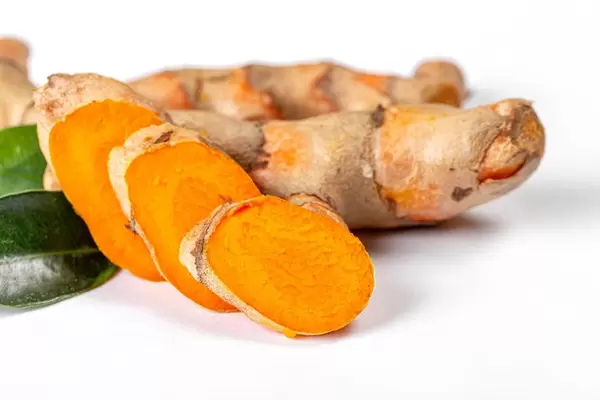 Cutting of turmeric roots with leaves on white background (Flip 2020)