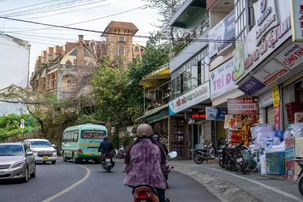 Da Lat Traffic with Cars, Public Bus and Scooters in the Cold Season with a View of Saphir Dalat Hotel in Vietnam