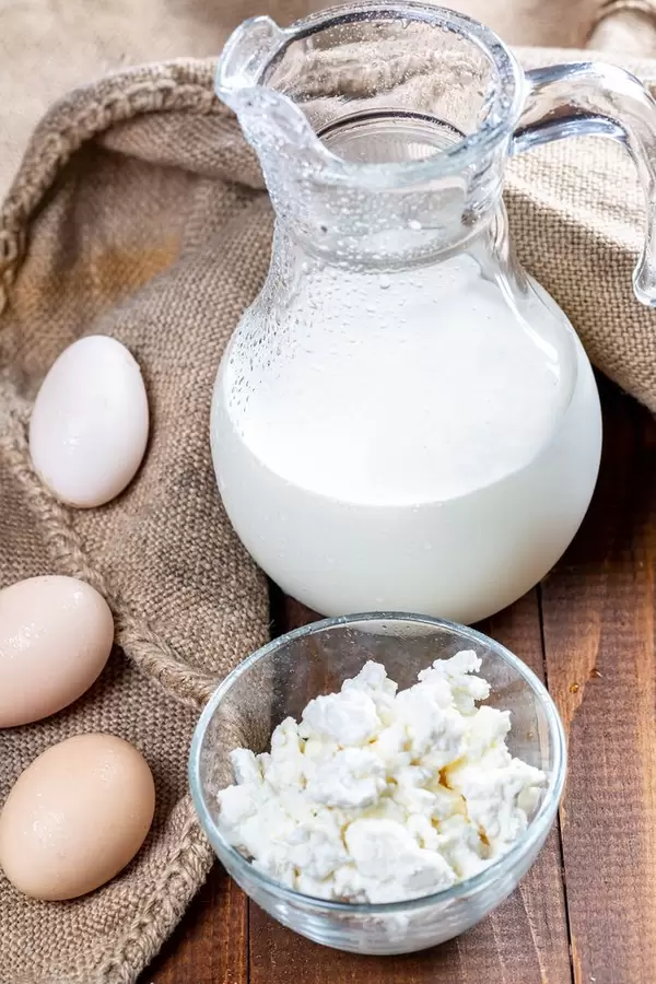 Dairy products and eggs on a wooden table with burlap  Flip 2019