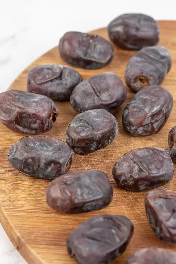 Date palm fruits on the kitchen board