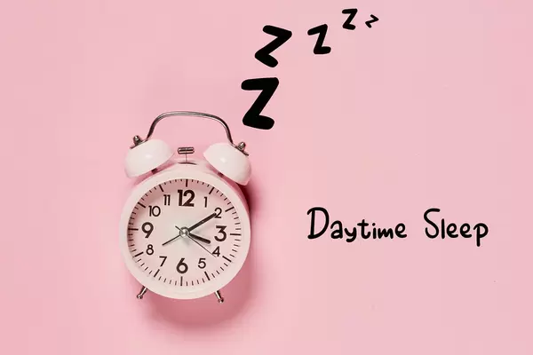 Daytime Sleep concept with alarm clock