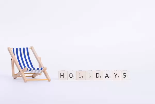 Deck chair with Holidays text on white background