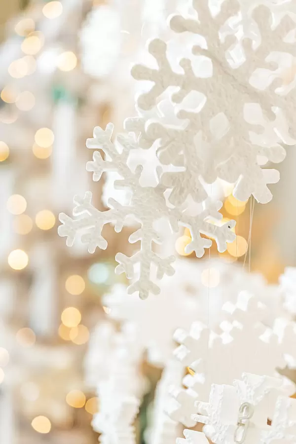 Decor white snowflakes on golden bokeh background