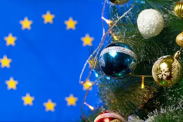 Decorated Christmas tree against the European Union flag