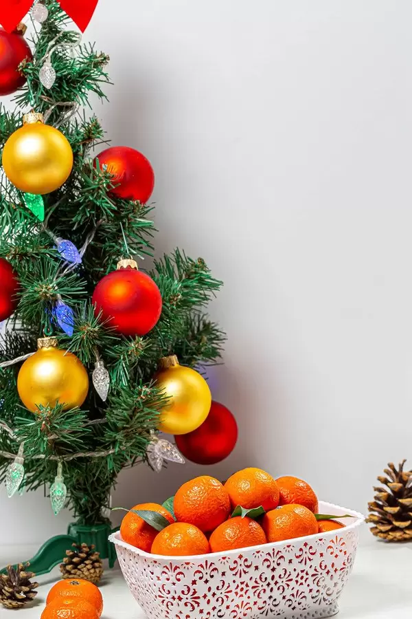 Decorated Christmas tree with a box of ripe tangerines (Flip 2019)