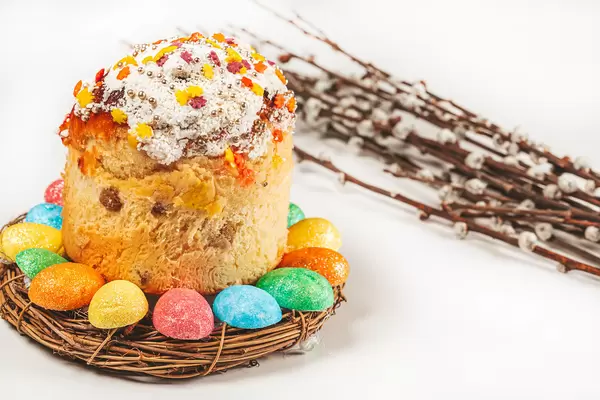 Decorated easter cake with willow branches on white
