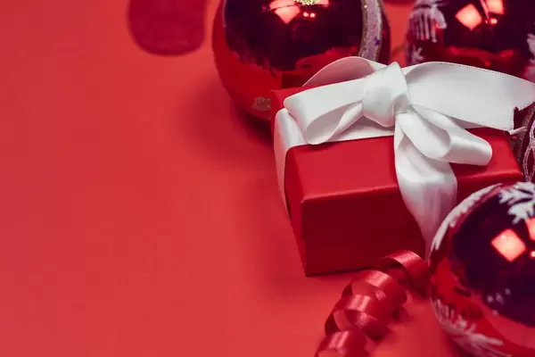 Decorative Christmas toys and gift box on the red background