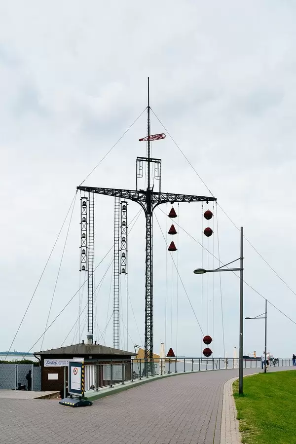 Decorative mast with bells next to the beach and Maritime Museum