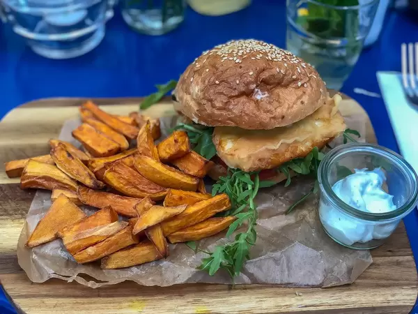 Deep fried Halloumi Burger at Augustin in Vienna: halloumi, arugula, red onions, tomatoes, dijonnaise, sweet potato fries, yoghurt-mint dip