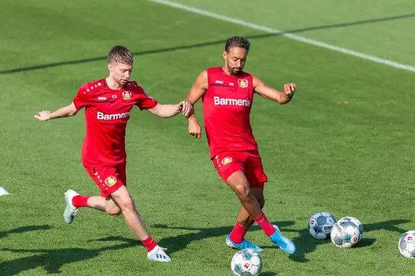 Defender Mitchell Weiser and football colleague Karim Bellarabi fight for the ball during training session in Germany
