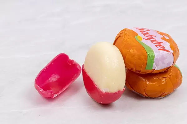 Delicious Babybel cheese on the grey table