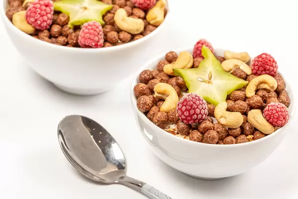Delicious breakfast background with starfruit, almonds and raspberries