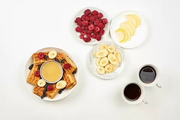 Delicious breakfast with fruits and sweet desserts for two persons