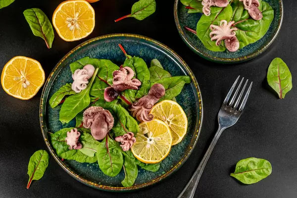 Delicious dietary salad with pickled octopus, top view