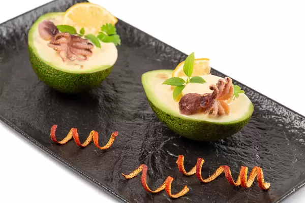 Delicious dish with avocado, octopus and creamy sauce
