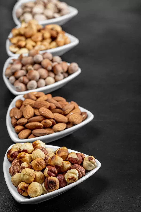 Delicious fried nuts on a black background