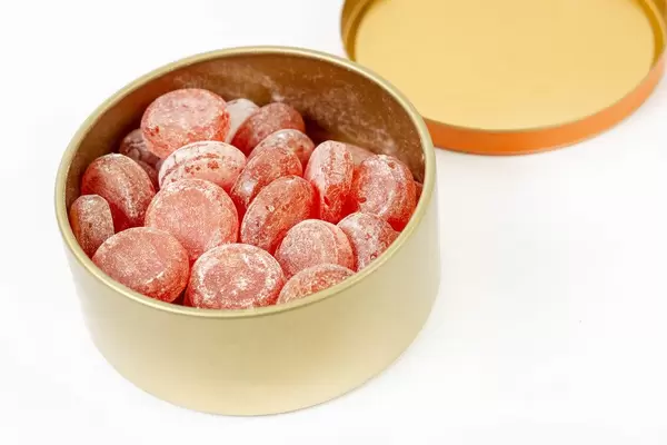 Delicious Fruit Candies in the box above white background (Flip 2019)