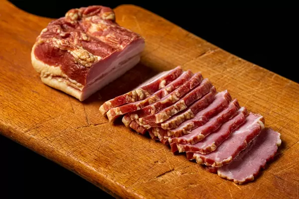 Delicious homemade smoked bacon on a cutting board