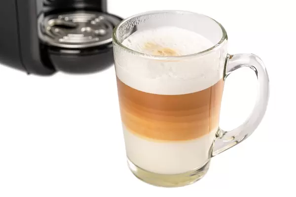 Delicious hot latte coffee in a glass mug