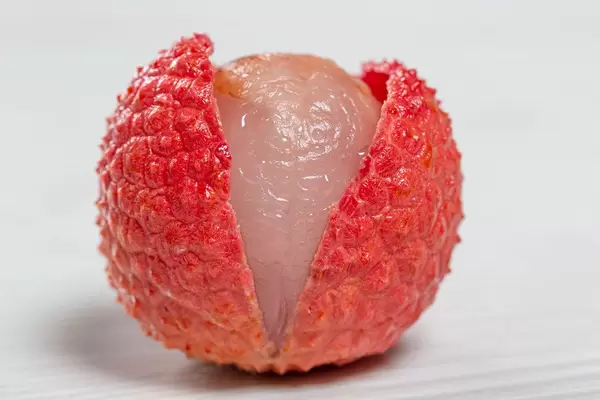 Delicious juicy red lychee over white background