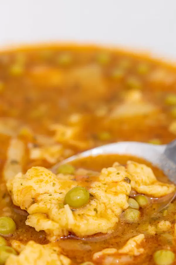 Delicious Peas and vegetable soup with dough croutons