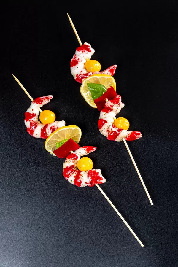 Delicious skewers of shrimp on a wooden sticks