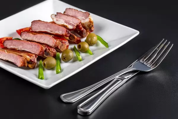 Delicious smoked ribs with jalapeno pepper slices and olives