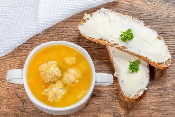 Delicious soup with potatoes and chicken meatballs in tureen and cheese sandwiches (Flip 2019)