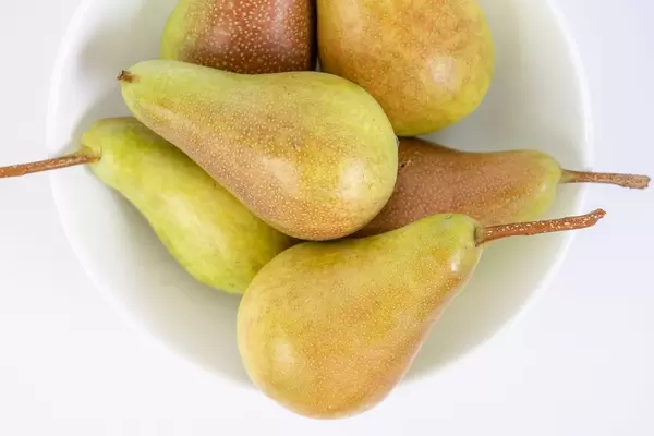 Delicious Sweet Pears in the bowl above white background