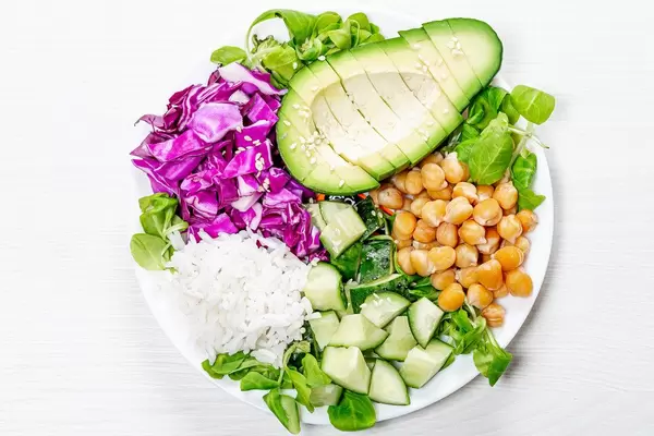 Delicious vegetarian lunch with fresh vegetables, chickpeas and rice. Top view (Flip 2019)