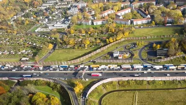 Delivery trucks and cars stuck in traffic jam on a German Autobahn
