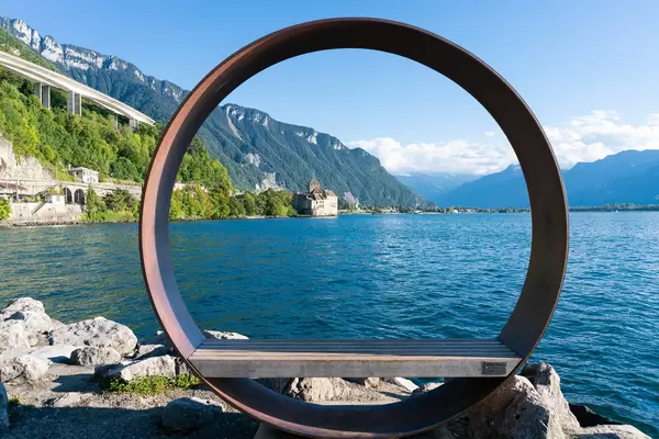 Designer street bench with round circle above it in picturesque surrounding at Lake Geneva